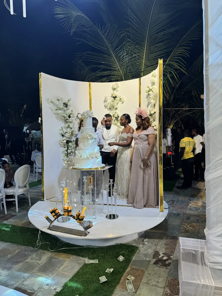 A wedding party gathered for the cake cutting